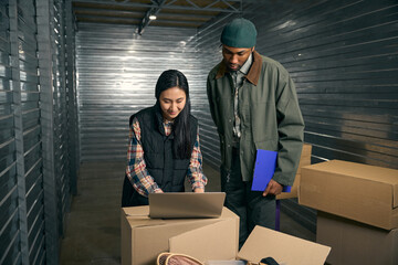 Two people working together in storage unit