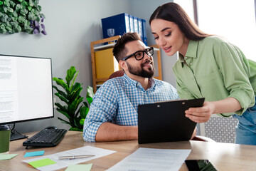 Photo of two people worker boss sit table look passionate girl secretary show checklist in office