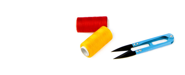 Scissors and a skeins of thread for sewing isolated on a white. There is free space for text. Collage. Wide photo.