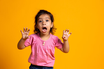 Beautiful Caucasian young girl standing against yellow background scared . Human emotions, facial...