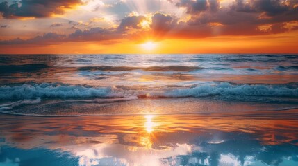 Fototapeta premium A stunning sunset over the ocean waves, reflecting vibrant colors on the water surface under a dramatic cloudy sky, creating a serene atmosphere.