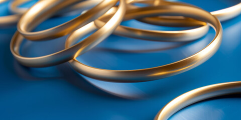 Elegant Gold Bangles on Reflective Blue Background   Stylish Jewelry Accessory