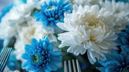 Close up of white and blue chrysanthemum arrangement with utensils