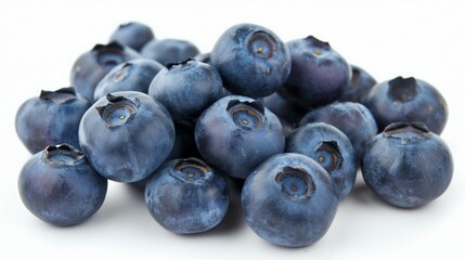 Heap of fresh blueberries isolated on white background showing detailed juicy blue berries