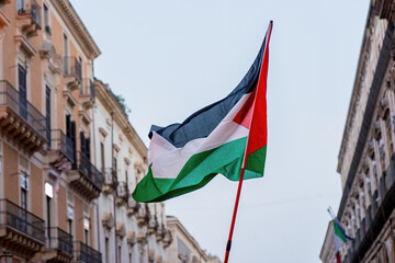 Palestinian Flag Waving in the City - Symbol of Freedom and Solidarity