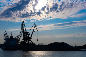 Fototapeta premium Gdynia port at sunset time, silhouettes and sea, Poland