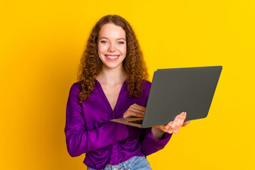 Fototapeta premium Photo portrait of lovely young lady hold netbook dressed stylish violet garment isolated on yellow color background