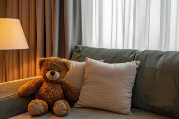 A comfortable sofa with pillows and a teddy bear