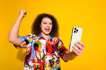 Photo portrait of lovely young lady winning hold excited gadget dressed stylish colorful print...