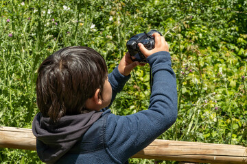 Child exploring nature with camera on a spring weekend
