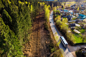 View from a drone of a clearing cut down on the outskirts of the forest near the road, gas laying...
