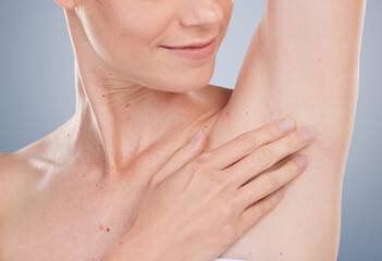 Person, smile and touching armpit for hygiene with studio background for fresh smell, wellness and...