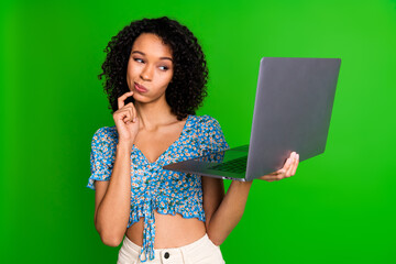 Photo of nice young woman think use laptop wear top isolated on green color background