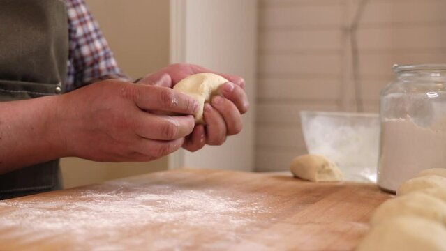 a male chef makes kutab dough in a home kitchen