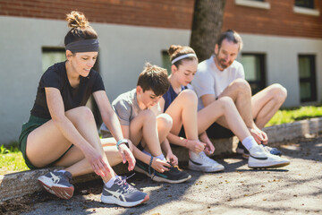 Naklejka premium A Family exercising and jogging together at an outdoor park having great fun