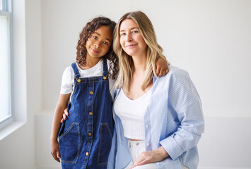 An Adorable black american little girl with her mother on studio