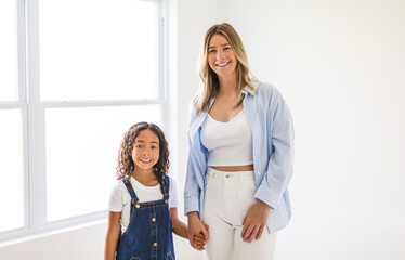 An Adorable black american little girl with her mother on studio