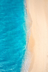 Summer seascape beautiful closeup. Blue sea water in sunny day. Top view from drone. Sea aerial surf, amazing tropical nature background. Mediterranean bright sea bay waves splashing beach sandy coast