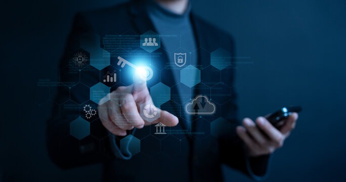 Business man holding and managed his cybersecurity and privacy to protect data by key icon holographic technology. protecting personal data on virtual interfaces, getting keys to successfully in work