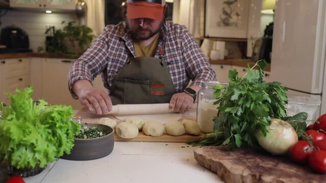 a male chef makes kutab dough in a home kitchen