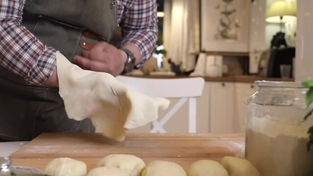 a male chef makes kutab dough in a home kitchen
