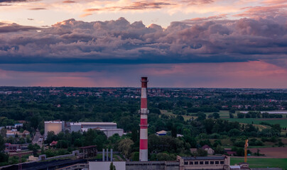 city ​​during sunset from drone. Aerial view of the city skyline, cityscape. View of architecture, industrial plants, warehouses