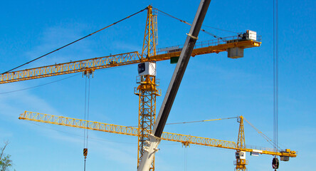 construction site including steel structure and cranes