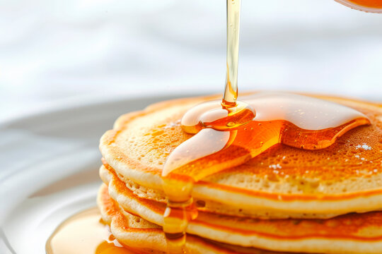Syrup pouring on stack of pancakes with bright backdrop. Generative AI image