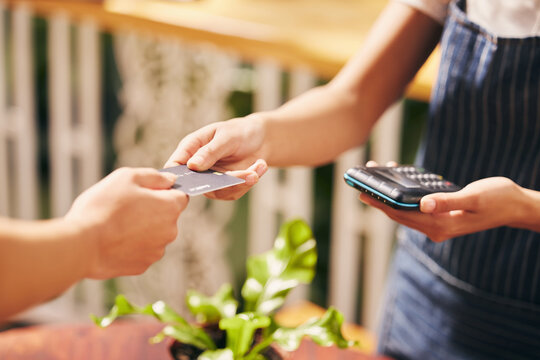 Credit card, hands and cashier for payment, machine and financial transaction with banking account. Purchase, zoom and woman at pos in store with fintech for shopping, sale and bills as exchange