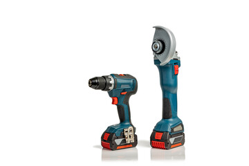 Professional cordless drill driver and angle grinder power tools isolated on a white background with copy space; instruments for DIY or trade isolated on white; drill and angle grinder side view.