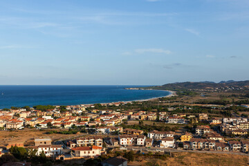Naklejka premium La Caletta, Sardinia: Coastal town, Mediterranean Sea, sandy beach, summer vacation.