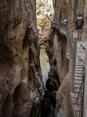 Tourists walking on the walkway at the gorge canyon of the El Caminito del Rey in Andalusia