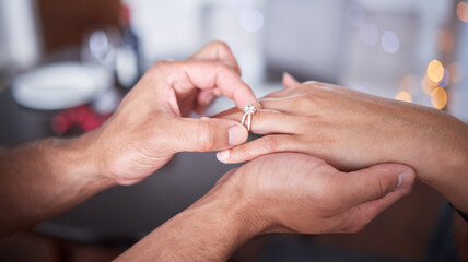 Hand, ring and couple engagement in home for love, commitment and promise for marriage with care or...