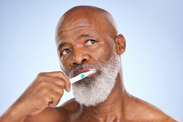 Toothbrush, face and black man for dental healthcare, studio or oral hygiene on blue background....
