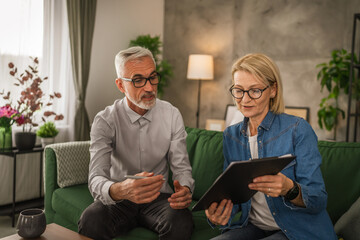 Mature senior woman wife show to man husband where to sign document