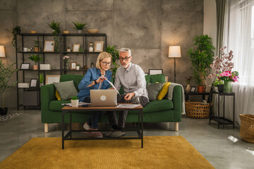 Mature man and woman work form home have consultation via video call