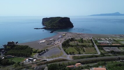 approaching flight aerial view of natural beauty of Dino island in south Italy surrounded by crystalline and turquoise shades color sea on summer sun light - Powered by Adobe