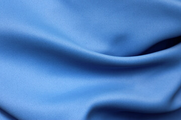 Abstract blue draped wrinkled fabric close up as a background