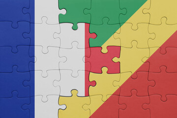 puzzle with the colourful national flag of republic of the congo and flag of france.