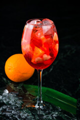 Classic italian aperol spritz cocktail in glass on dark