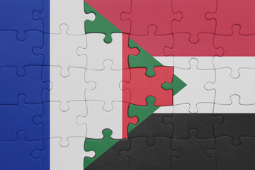 puzzle with the colourful national flag of sudan and flag of france.