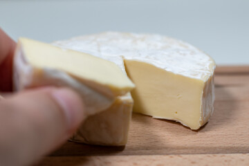 fresh brie cheese on a wooden background. High quality photo