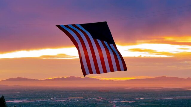 United State Flag flies in a canyon overlooking Ogden Utah