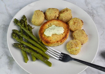 salmon burger top with tarter sauce  with scallops
