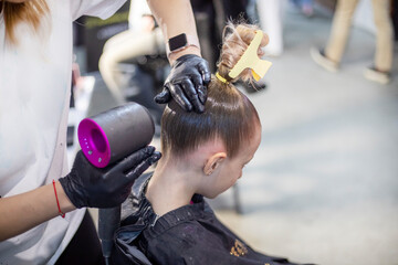 stylist does a girl's hair before entering a ballroom dancing tournament