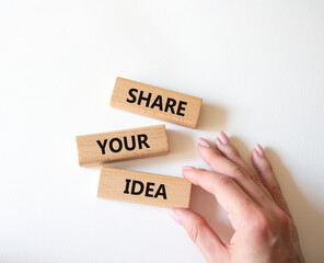 Share your Idea symbol. Concept words Share your Idea on wooden blocks. Businessman hand. Beautiful white background. Business and Share your Idea concept. Copy space.