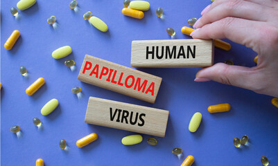 Human Papilloma Virus symbol. Concept word Human Papilloma Virus on wooden blocks. Doctor hand....