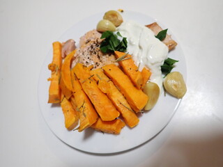 fresh vegetable salad with salmon and fries