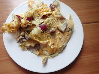 scrambled eggs with onion on a plate