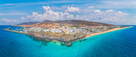 Landscape with Morro Jable in Fuerteventura, with azure waters and sandy shores offering a tranquil...